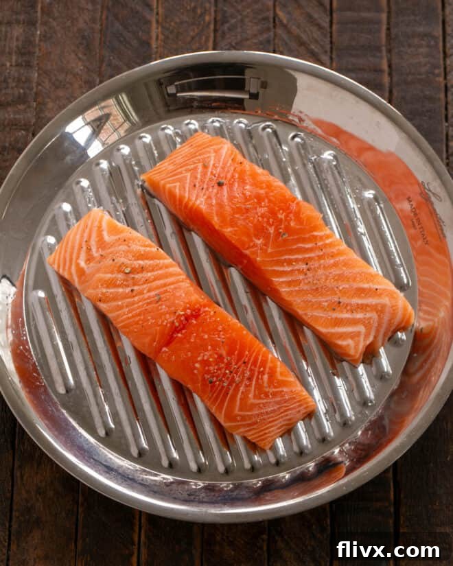 Sweet and Tangy Maple Mustard Salmon 4 Fresh salmon fillets are patted dry with paper towels and placed skin-side down on an oiled grill pan.