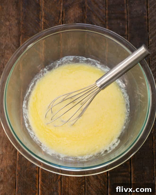Melted butter, milk, buttermilk and egg mixed in a bowl.