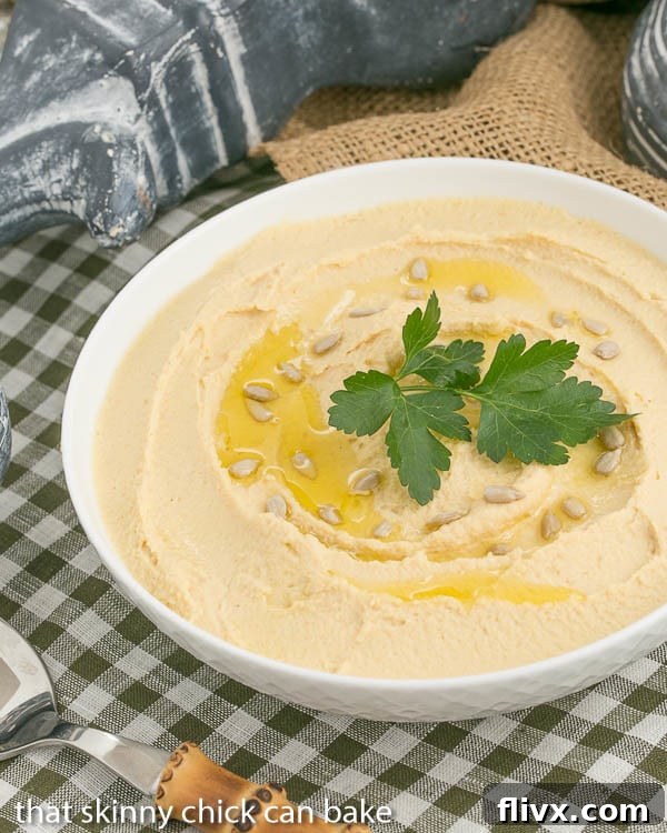 Hummus: A close-up view of creamy Classic Hummus, subtly flavored with fresh lemon and aromatic garlic, showcasing its smooth texture.