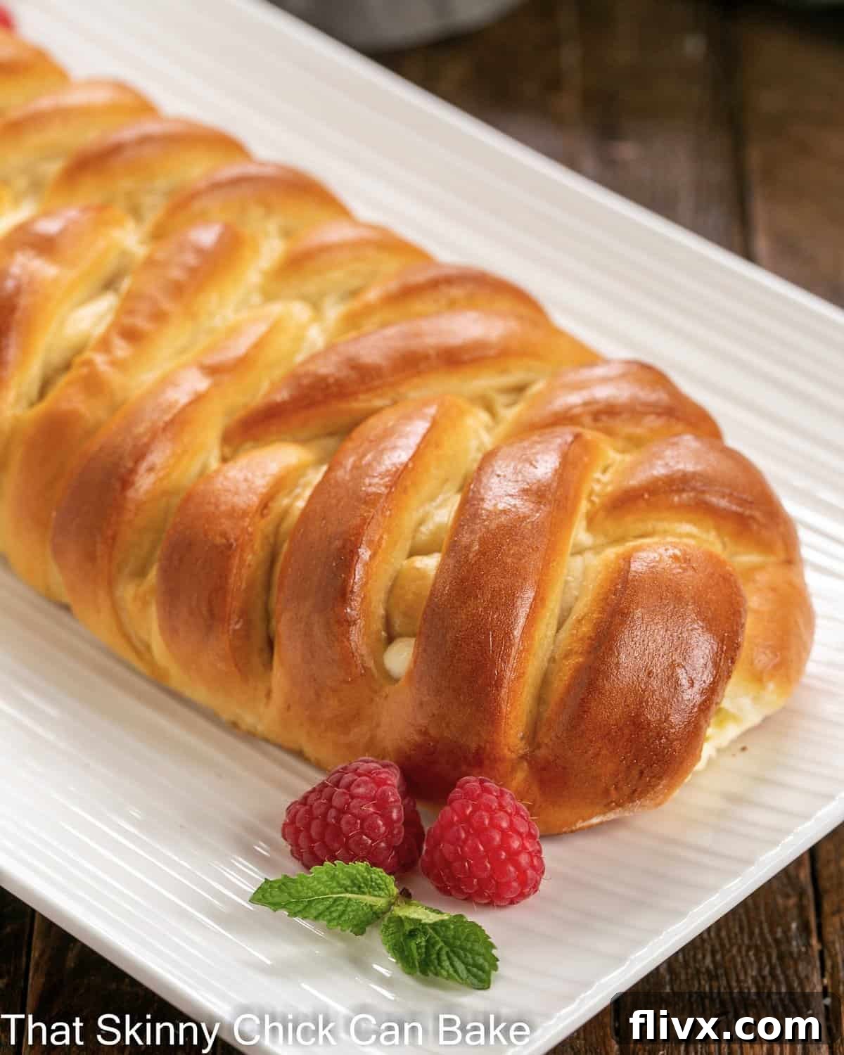 Cream cheese filled Easter bread on a white serving dish, beautifully plaited.