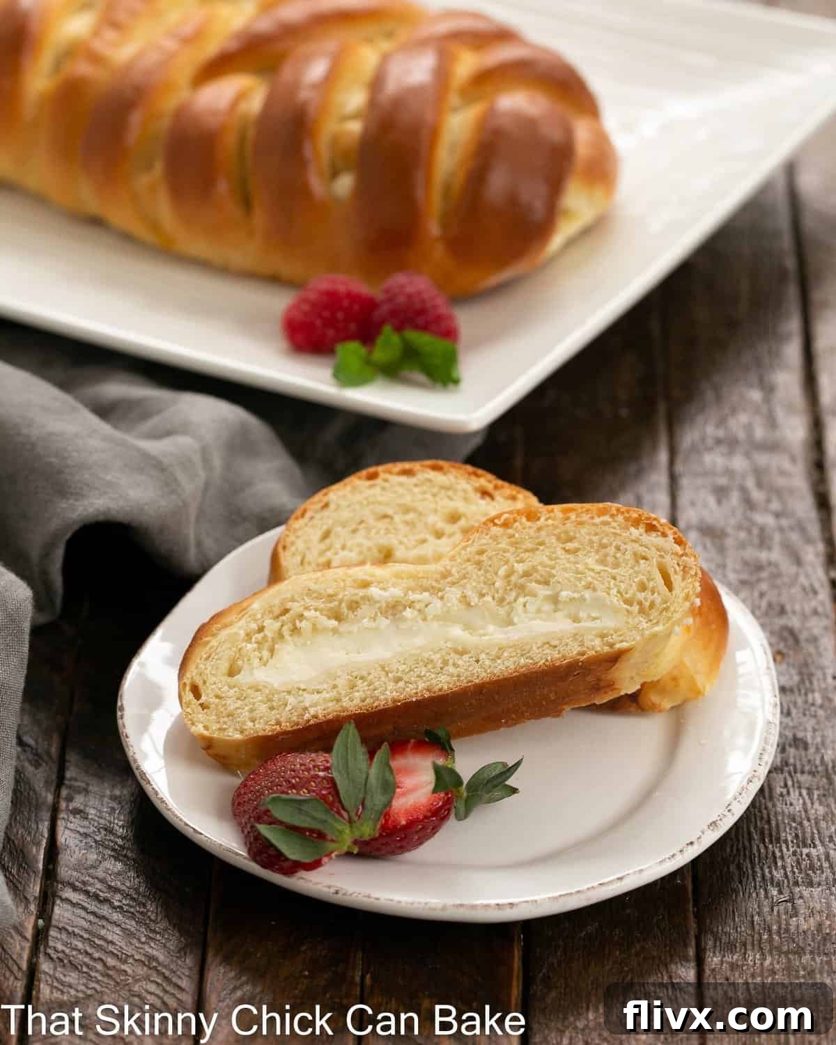 Slices of Easter bread with cream cheese filling in front of a full serving tray.