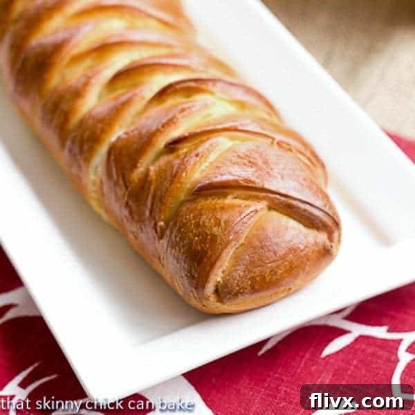 Plaited Easter Bread on a white tray, showing its beautiful golden crust and delicate braid.