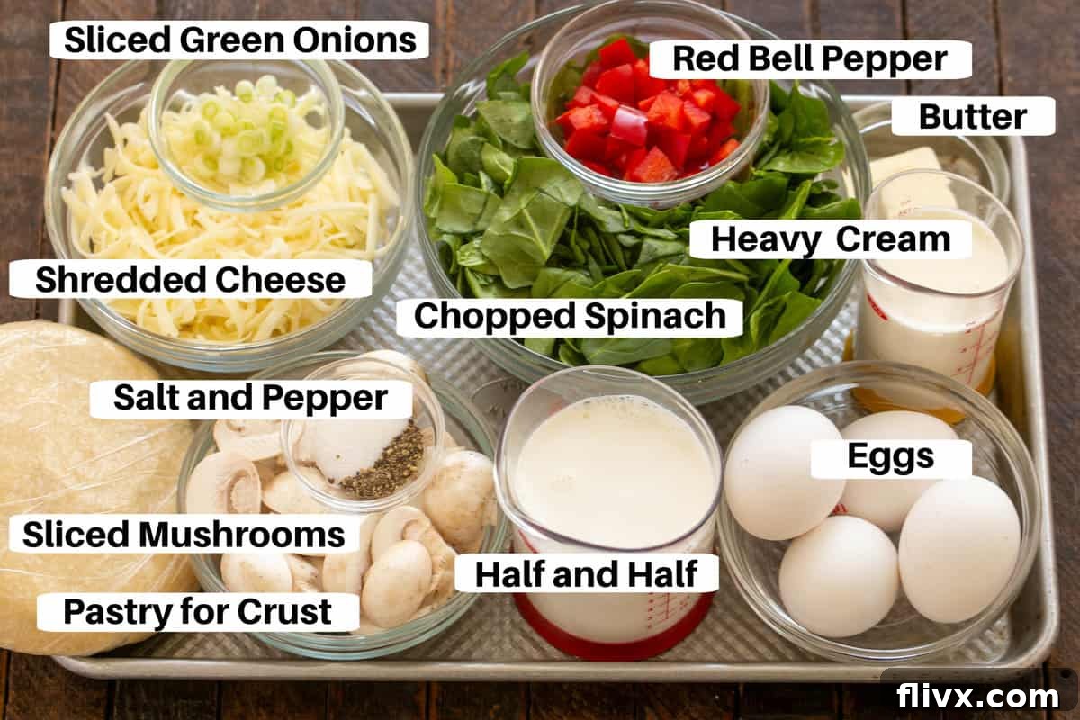 Individual ingredients for Spinach Quiche neatly arranged with labels on a metal sheet pan, ready for preparation.