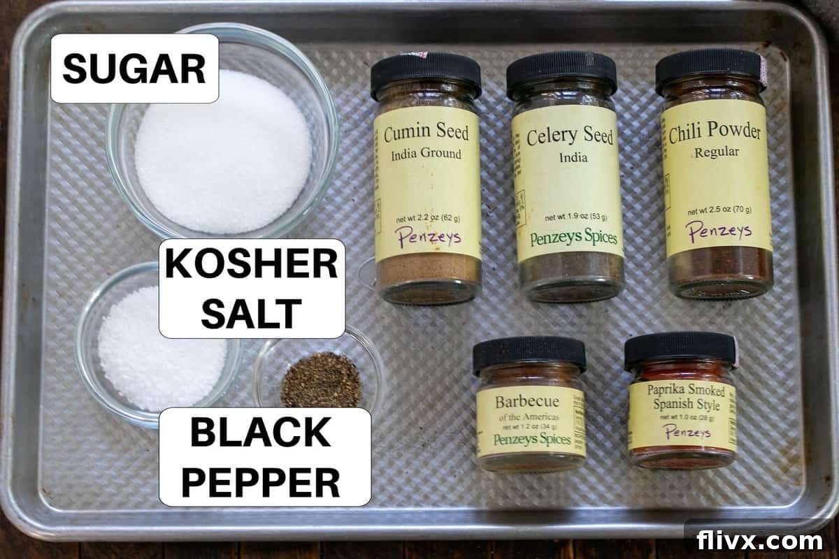 Various dry rub ingredients for Baby Back Ribs, clearly labeled, arranged neatly on a sheet pan, ready for mixing.