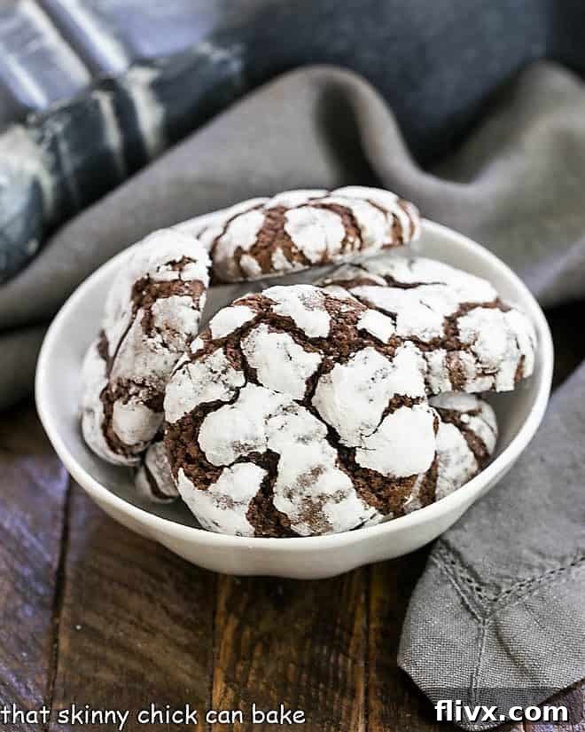Earthquake Cookies Step 10: Finished chocolate crinkle cookies in a white ceramic bowl.
