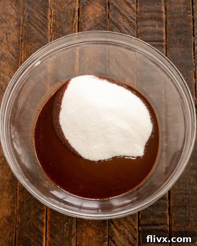 Earthquake Cookies Step 2: Adding granulated sugar to the melted chocolate and butter.