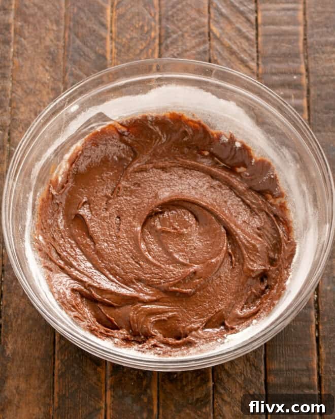 Earthquake Cookies Step 6: Mixing vanilla extract into the cookie dough.