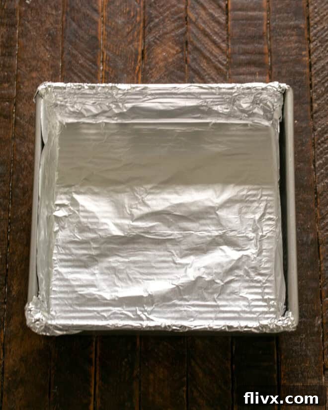Step 1: Line an 8x8 inch pan with nonstick foil, ensuring edges extend for easy lifting.
