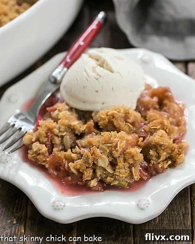 Close up view of easy rhubarb crisp on a white dessert plate.