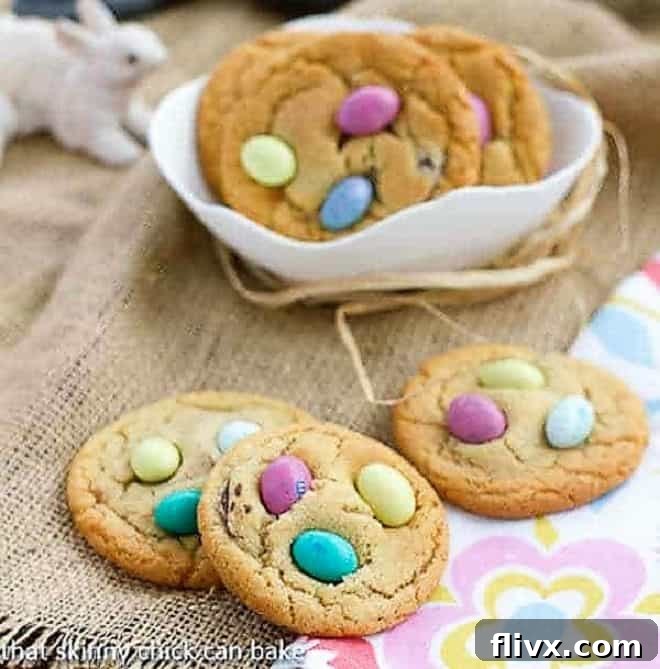 Easter Egg Cookies on a spring floral napkin and in a white bowl, ready to be served for a festive occasion.