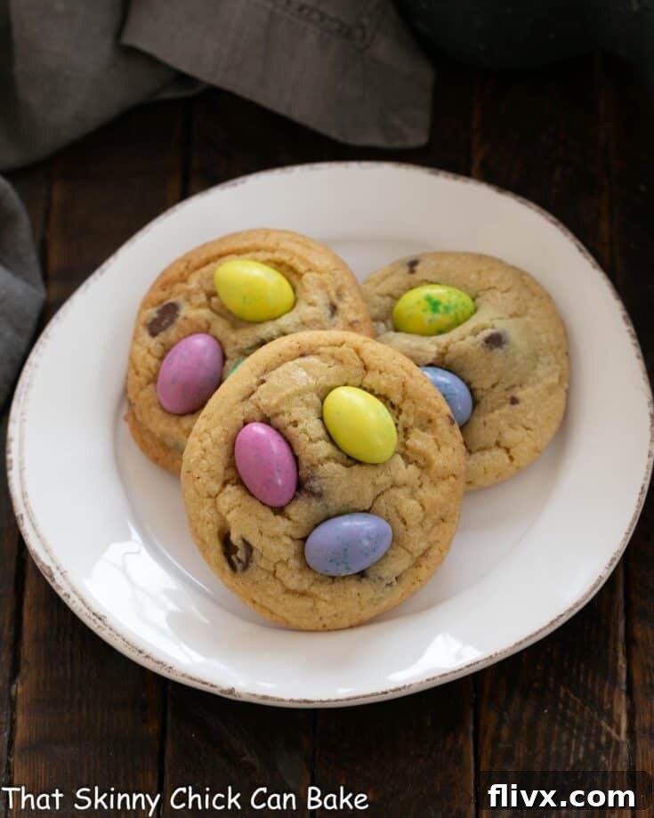 Overhead view of 3 Easter M&M Cookies on a white plate, showcasing vibrant colors and perfect texture.