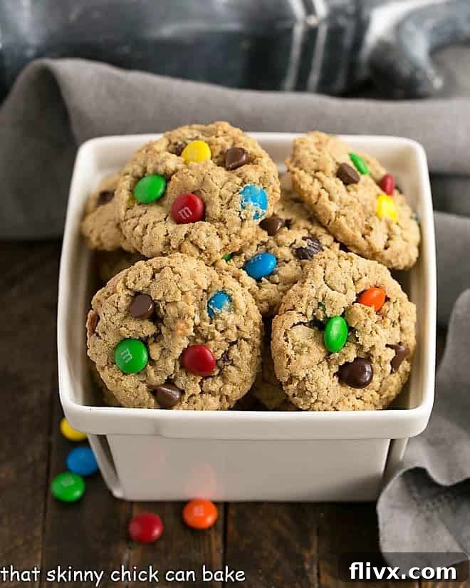 Classic Monster Cookies piled in a ceramic basket.