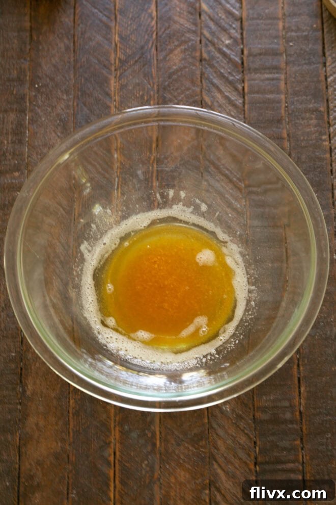 Butter being melted and browned in a saucepan until it reaches a rich golden brown color with nutty aromas.