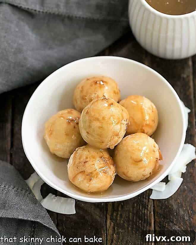 Beautifully golden-brown Fried Sticky Rice Balls (Carioca) elegantly presented in a pristine white serving bowl, ready to be enjoyed as a delightful Filipino dessert.