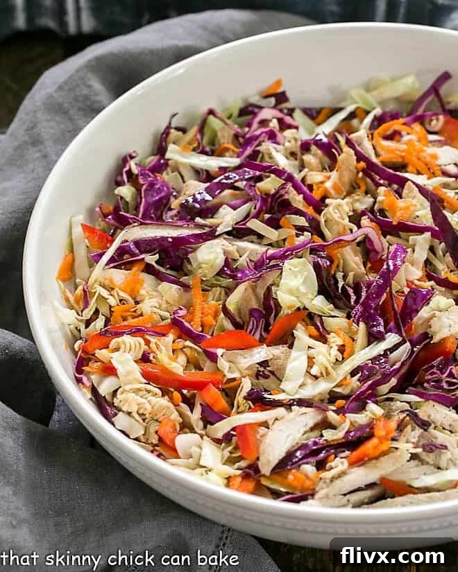 Asian Ramen Noodle Salad with Chicken in a white ceramic serving bowl.