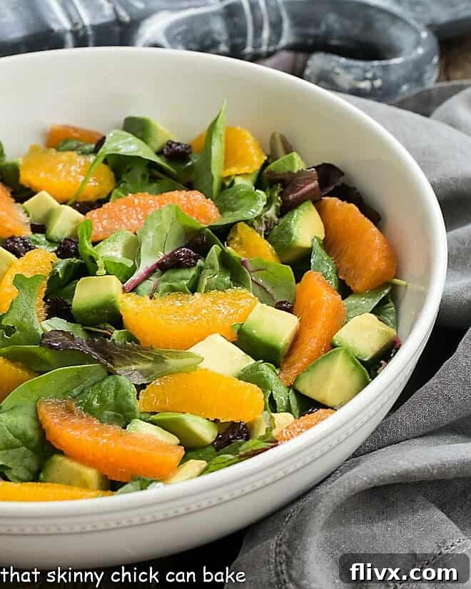 Cherry Orange Salad with Citrus Vinaigrette in a white serving bowl, showcasing vibrant colors.