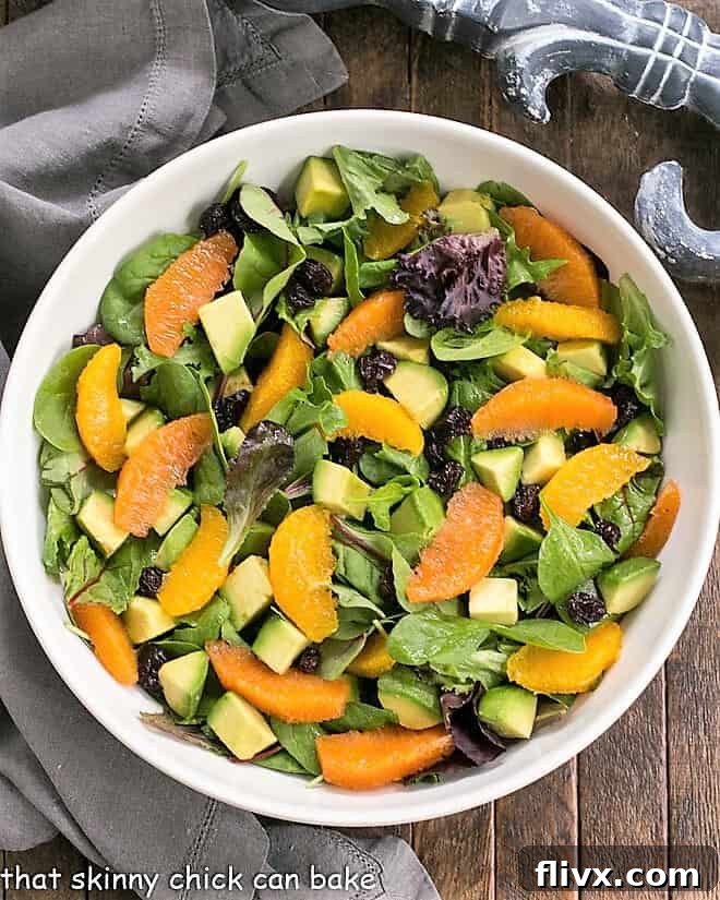 Overhead view of Orange Salad in a white serving bowl, highlighting the colorful ingredients.