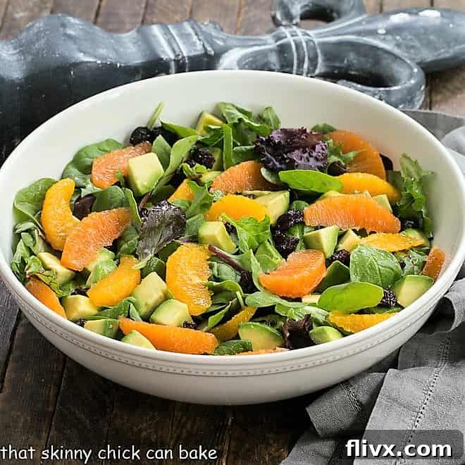 Cherry Orange Salad with Citrus Vinaigrette in a white ceramic serving bowl, ready to be served.