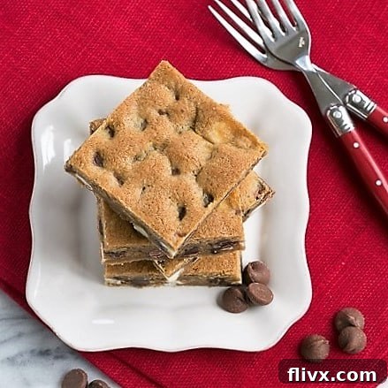 Overhead view of a stack of Homemade Chocolate Chip Bars, showcasing the melty chocolate.
