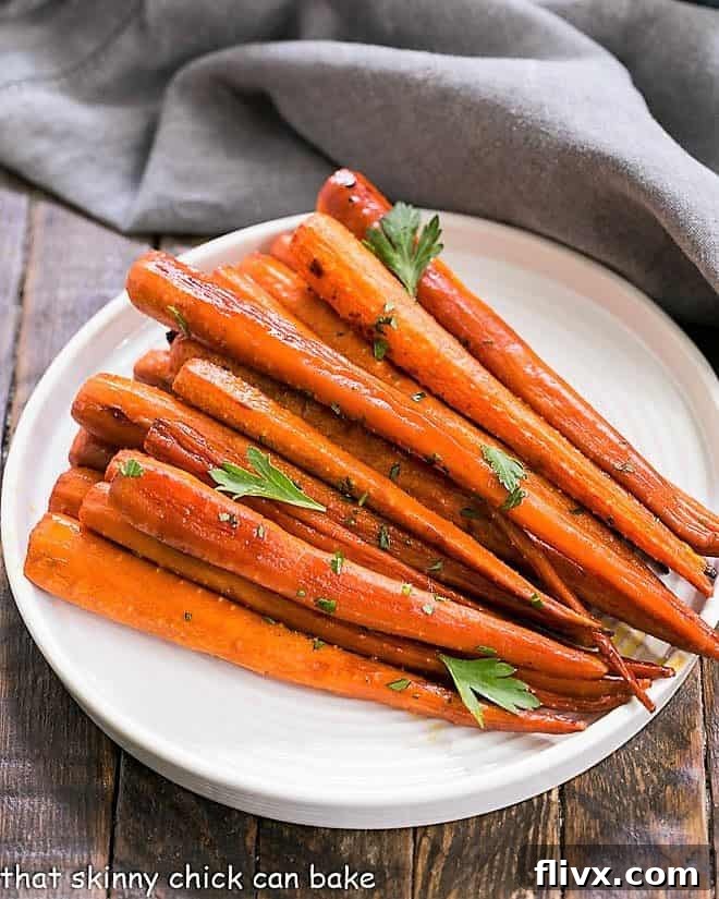 Honey Balsamic Roasted Carrots beautifully presented on a round, white ceramic plate, garnished and ready to be enjoyed.