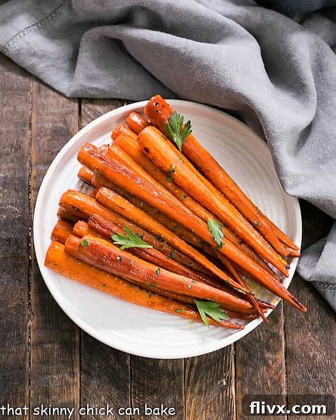 Beautifully glazed Honey Balsamic Roasted Carrots on a white ceramic plate, ready to be served.
