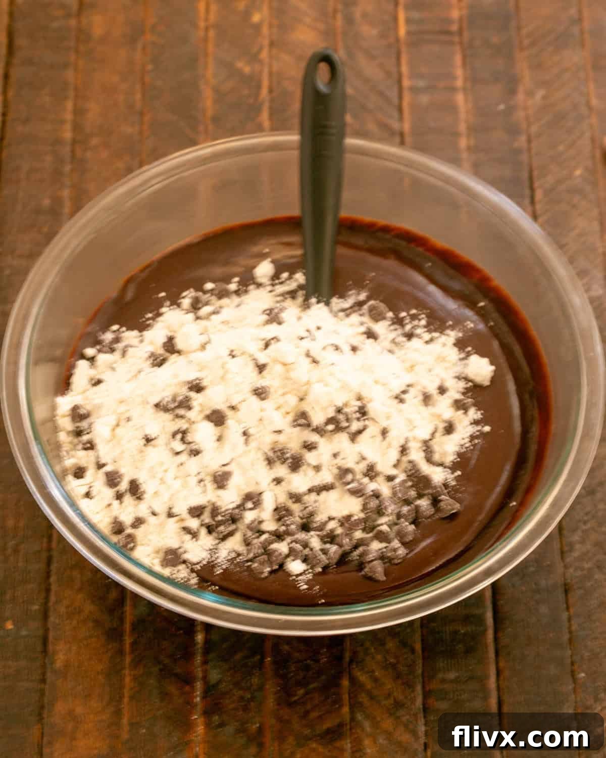 Step 7: Adding the chocolate chip-flour mixture to the cooled chocolate and egg mixture.