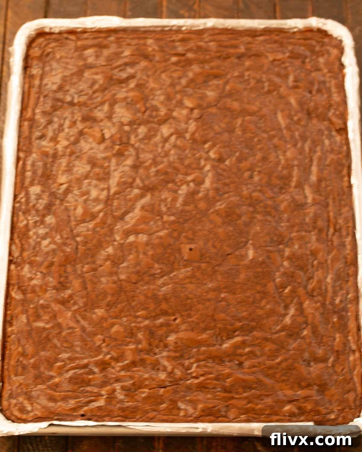 Step 10: Baked brownies in the sheet pan, cooling before cutting.