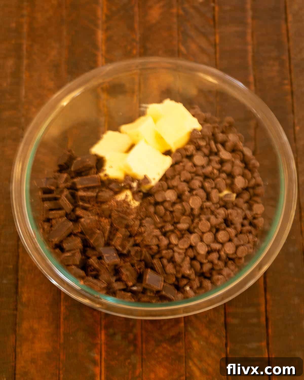 Step 1: Butter, chocolate chips, and chopped unsweetened chocolate in a heatproof bowl.
