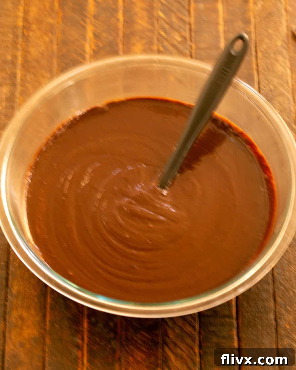 Step 4: Stirring the cooled chocolate mixture into the egg mixture.