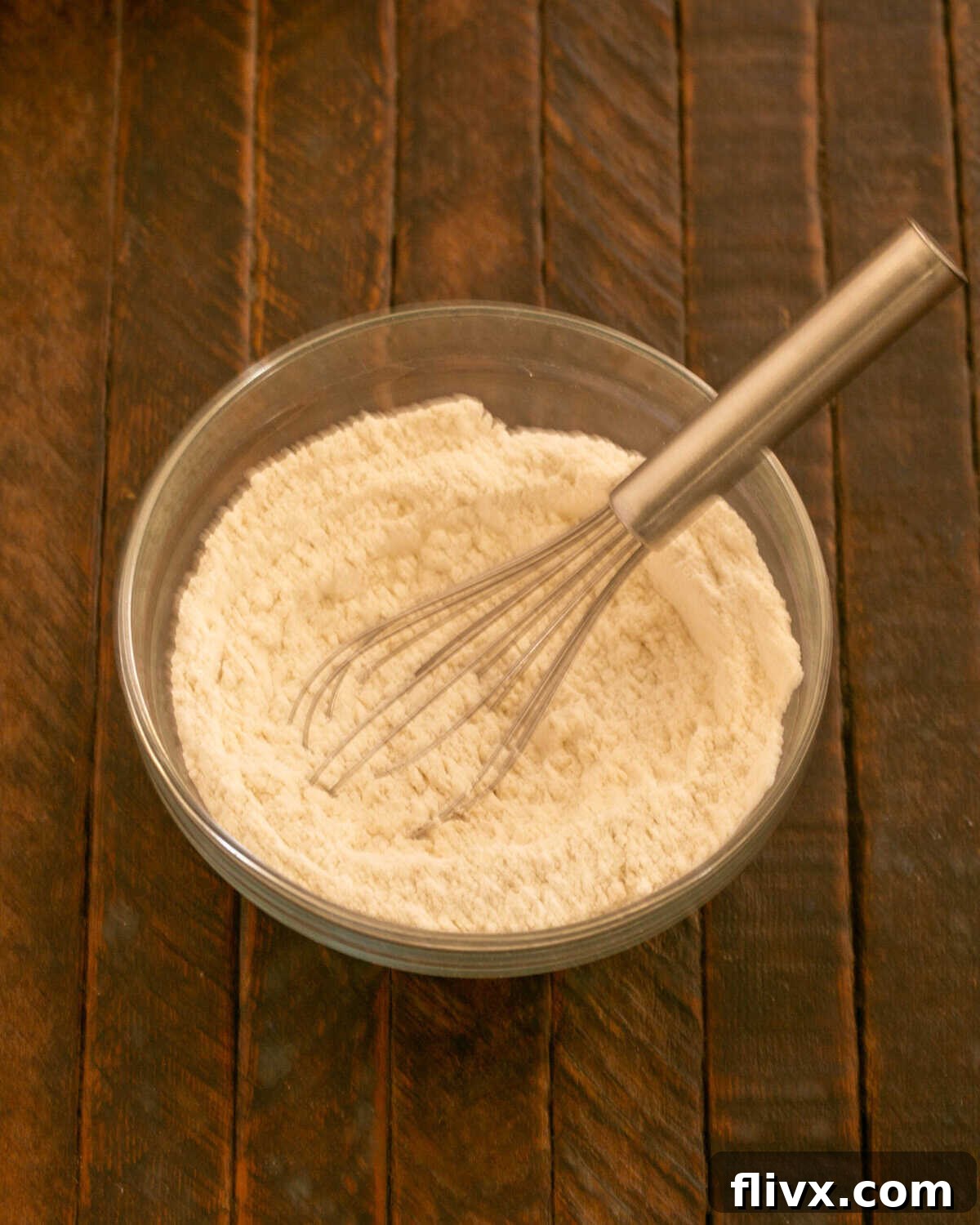 Step 5: Whisking together flour, baking powder, and salt in a bowl.