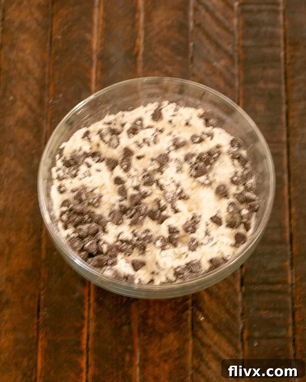 Step 6: Adding the remaining chocolate chips to the flour mixture.