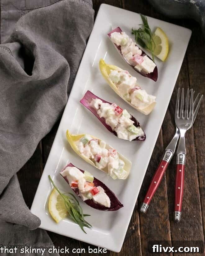 Overhead view of Lobster Salad in Endive Cups on a white rectangular tray