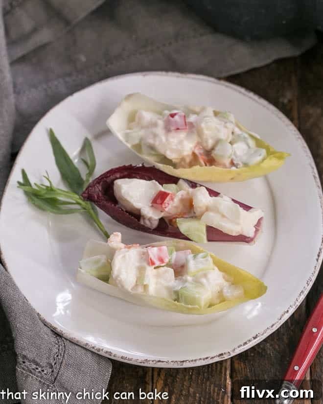 Overhead view of 3 Lobster Salad in Endive Cups on a white plate