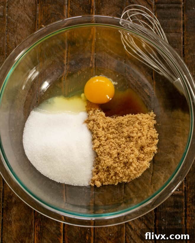 Step 1: Combine egg, granulated sugar, and brown sugar in a mixing bowl for the dark chocolate cupcake batter.