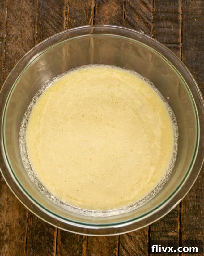 Step 3: Add milk, strong coffee or espresso, and melted butter to the whisked egg and sugar mixture.