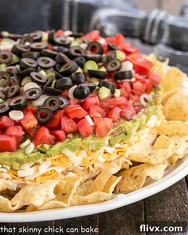 Side view of a perfectly layered 7 Layer Dip, showing the distinct colors and textures of each delicious component.
