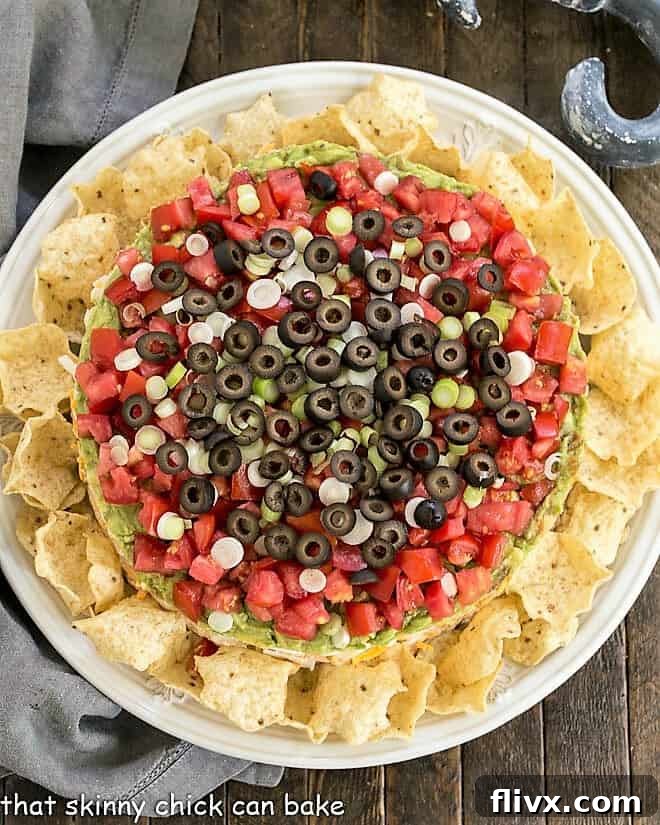 Overhead view of Layered Taco Dip surrounded by tortilla chips