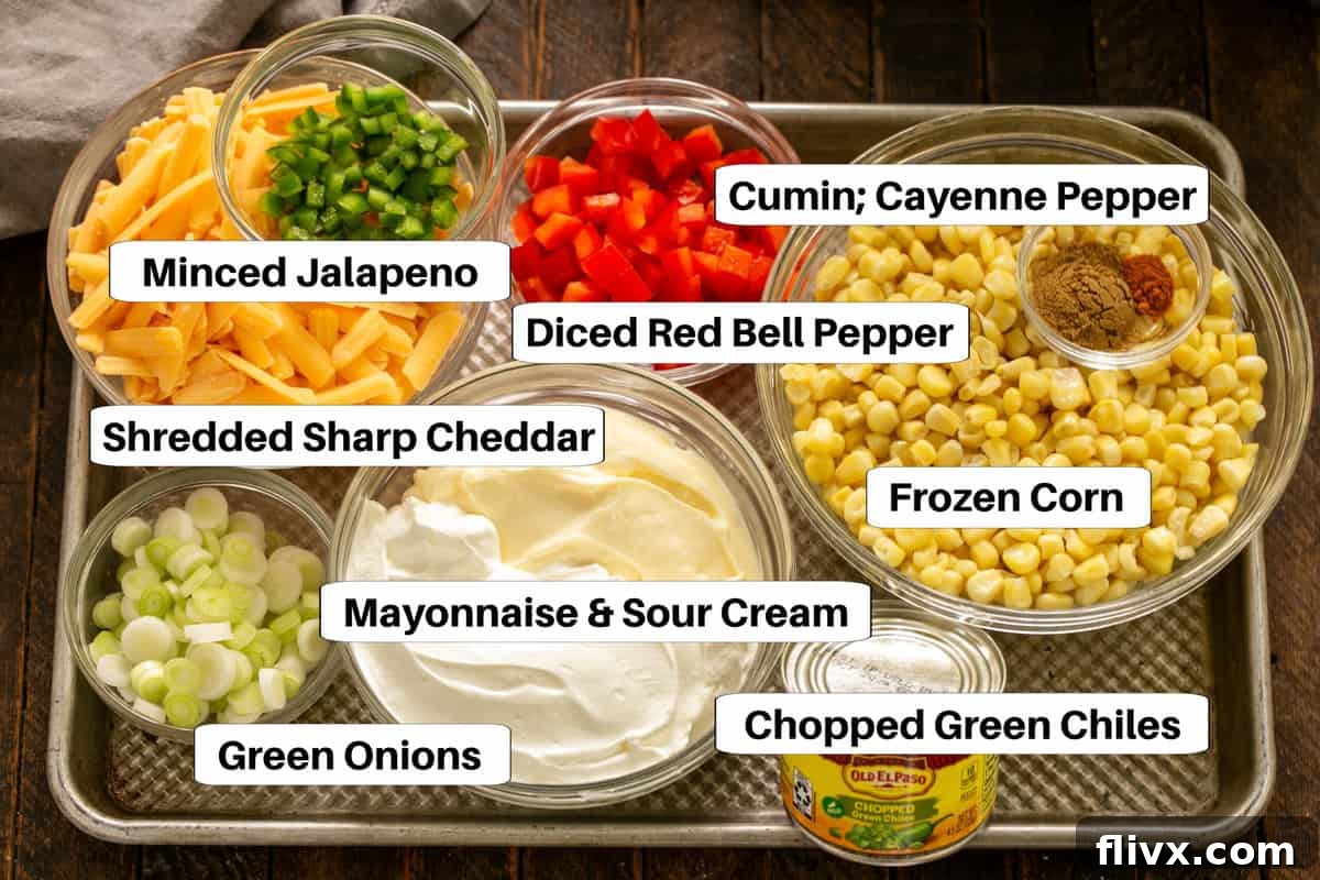 A beautifully arranged selection of Sour Cream Corn Dip Ingredients, neatly laid out on a sheet pan with clear labels for each item.