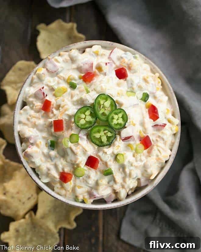 An inviting overhead view of the finished Sour Cream Corn Dip, perfectly presented in a charming round ceramic dish, garnished and ready for serving.