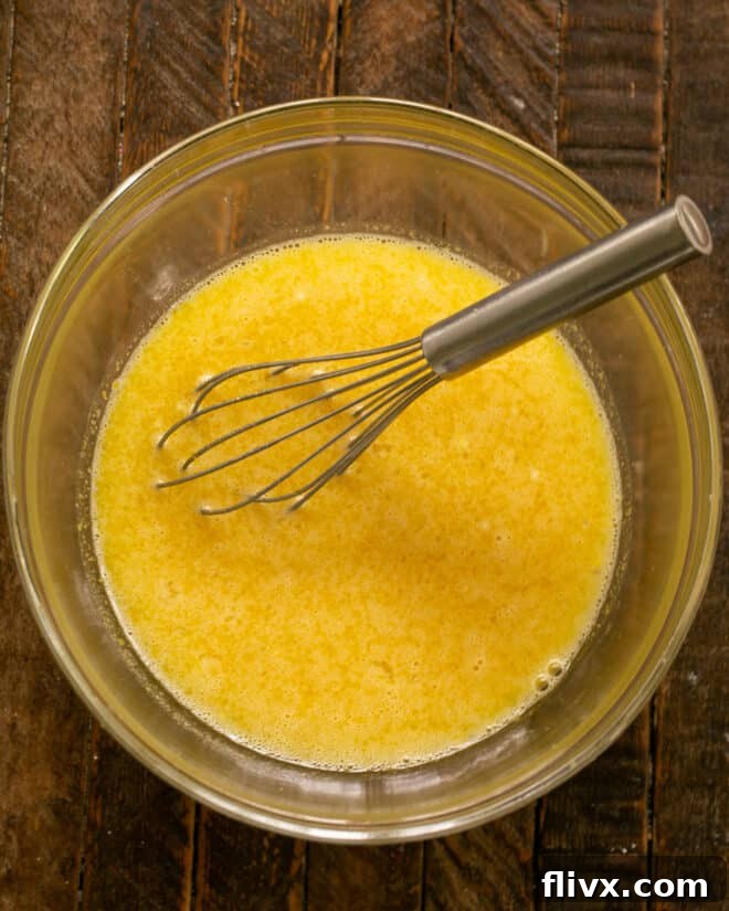 Mixed Lemon Custard Batter, smooth and yellow, ready to be poured over the cooled crust.