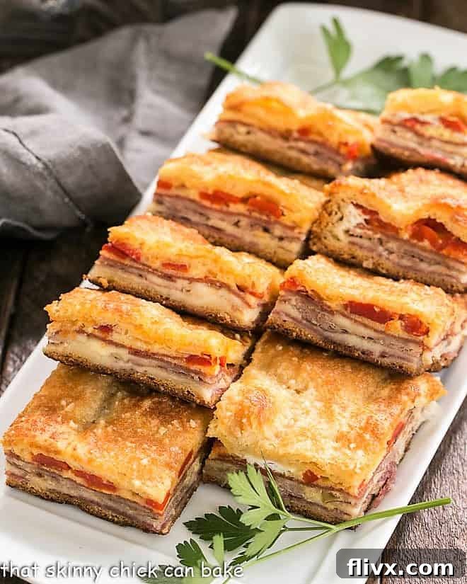 A rectangular platter filled with perfectly sliced Antipasto Squares, showcasing their delicious layers, ready to be served.
