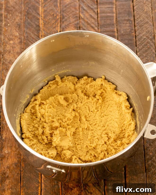 Step 2: Adding eggs, dry ingredients, and vanilla extract to the creamed mixture.