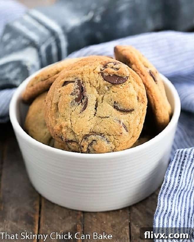 The Best Chocolate Chip Cookie recipe in a white bowl, showcasing their rich color and inviting texture.