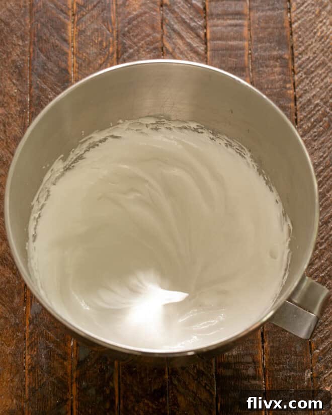 Step 3: Gradually beat in sugar until stiff & shiny.