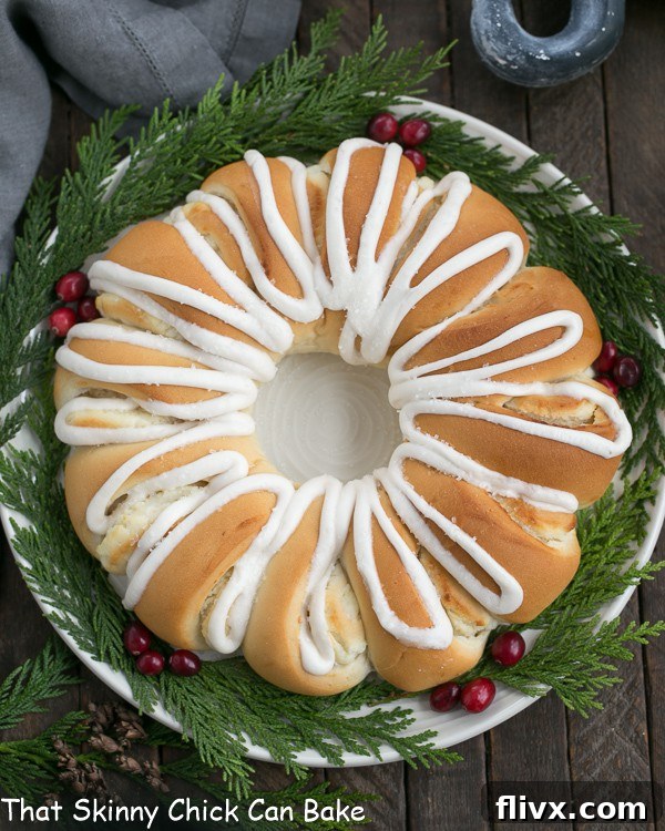 Overhead view of a golden brown Cream Cheese Tea Roll, beautifully glazed and ready to be served on a white plate, symbolizing comfort and indulgence.