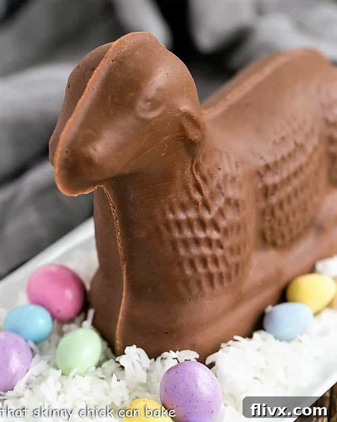 Fudge lamb on a bed of coconut with candy eggs on a white tray