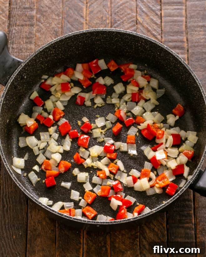 Soft Shell Tacos Step 1: Sauteing onions, garlic, and peppers in a skillet.