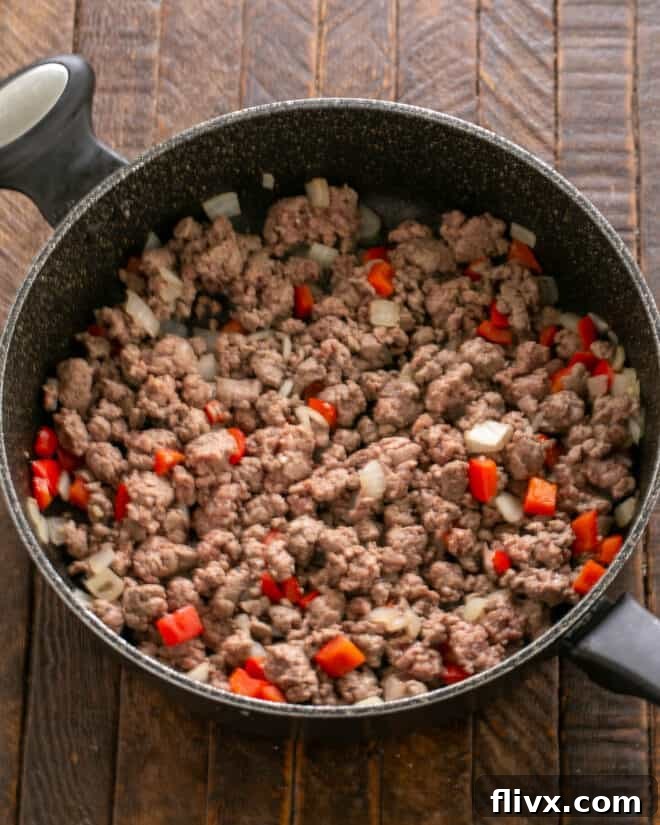 Soft Shell Tacos Step 3: Sprinkling taco seasonings over the cooked ground beef mixture.