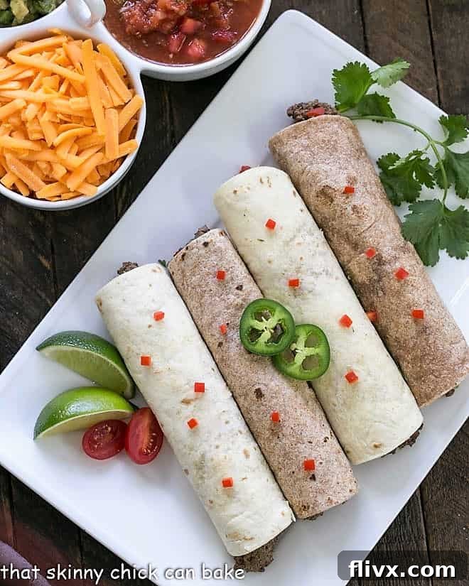 Overhead view of assembled soft shell beef tacos on a white platter, ready to serve.