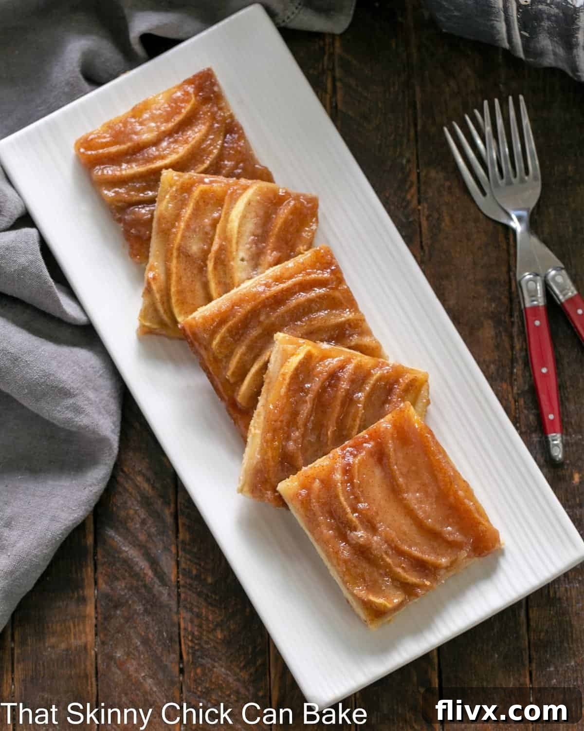 White platter with squares of apple kuchen.